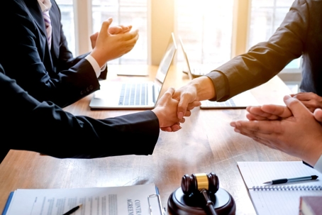 client and attorney shaking hands